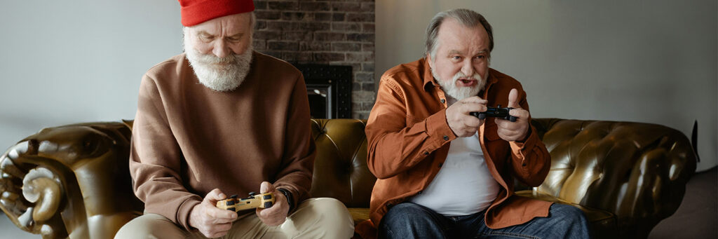 Two elderly men play video games