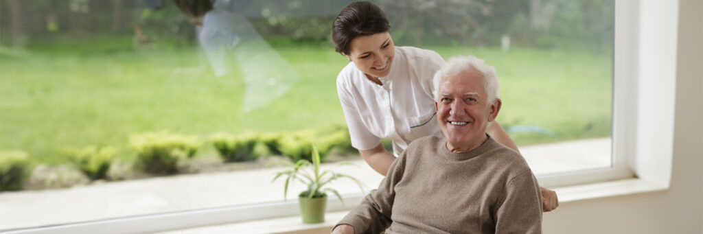 Elderly gentleman with home caregiver